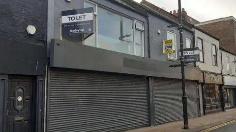 A general view of the buildings on Derwent Street in Sunderland. The buildings are on a main road, with shop space on the ground floor. 