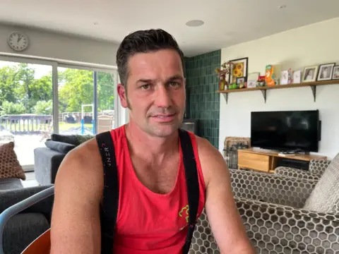 Shaun Whitmore/BBC Billy Crotty in his living room in Cambridgeshire