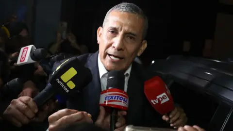 Former Peruvian President Ollanta Humala speaks in front of a number of microphones