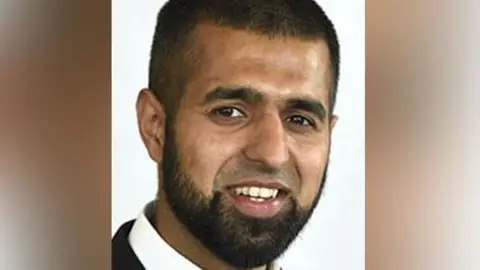 Head shot of Sohail Asghar. He has short dark hair and a beard, but no moustache