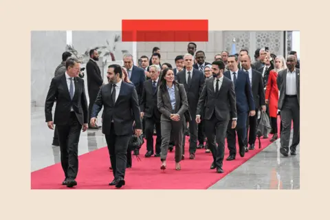 AFP via Getty Images Syrian Minister of Foreign Affairs and Expatriates Asaad Al-Shaibani (front R) arrives to attend a reception with United Nations Security Council delegation at the Presidential Palace in Damascus on December 4, 2025