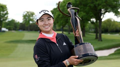 Rose Zhang posing with the Founders Cup trophy 