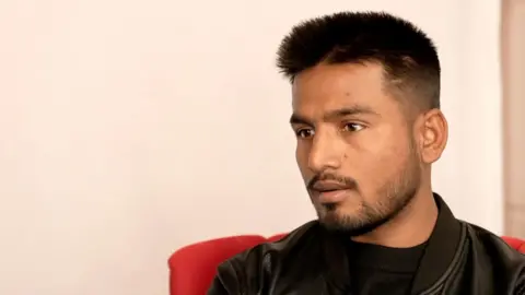 Bijay Gajmer Purushottam Suprabhat Yadav wears a black jacket and black T-shirt