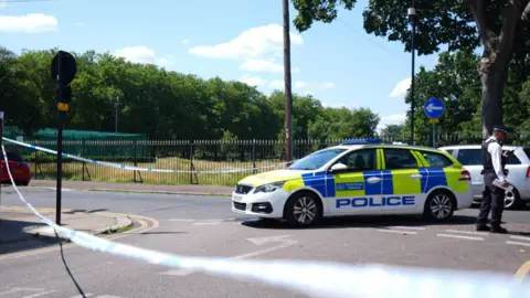 PA Media Police at Plashet Park, Newham, east London, after a man was stabbed to death