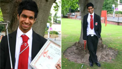 Wolverhampton Grammar School A composite of two images of Aaron Rai when he was a school student. He is wearing a black blazer and trousers, red tie and is stood against a tree. In the image on the right he is holding a golf club against his shoulder and a certificate. In the picture on the left, he is leaning on a golf club with his legs crossed.