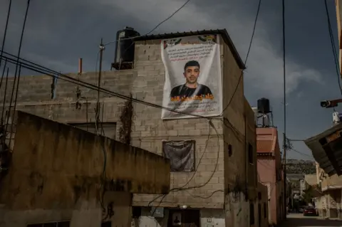 A large poster of Jad hangs from the ceiling of his family home in in al-Far'a refugee camp, in the occupied West Bank
