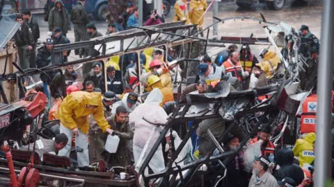 AFP Israeli rescue teams search for bodies in the wreckage of a bus destroyed by a suicide bomber on March 3, 1996 in central Jerusalem. At least 20 Israelis were killed in the blast.