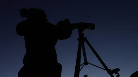 BBC/Tony Joliffe Jennifer Millard looks through a telescope 