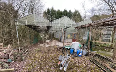 Peak UK Kayaking Ltd A picture of the derelict building. Graffiti can be seen sprayed on its glass walls.