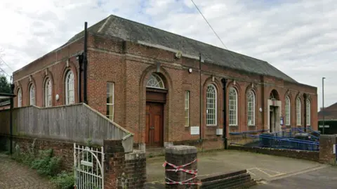 Google Streetview image of a red brick building, which is Charminster Library