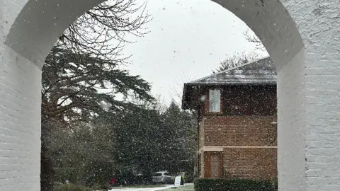 joshcellist Snow outside of a brick house. 