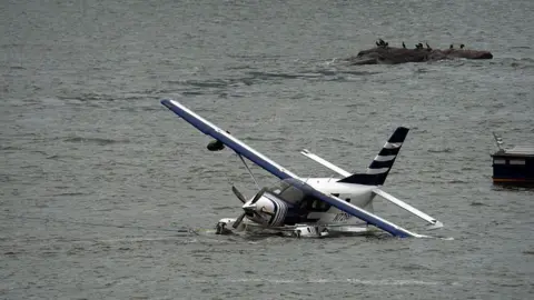 Emergency services respond to a crashed seaplane in the East River on 5 July in New York. 