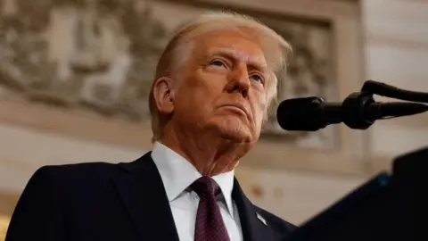 Donald Trump looks up   from a podium successful  a close-up.