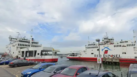 Two Red Funnel ferries at Town Quay in Southampton, with a line of parked cars on the quayside