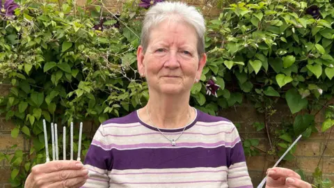 Jan Trevorah holding catheters