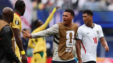 Morgan Rogers and Jude Bellingham react as they walk away from Ghana players