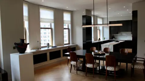 Grace Eliza Goodwin view of open-concept kitchen and modern dining furniture in residential unit, with large windows