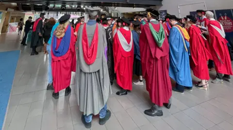 UWE UWE students in their graduation robes and hats in the foyer at the Bristol Beacon