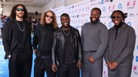Getty Images Ezra Collective band members on the red carpet