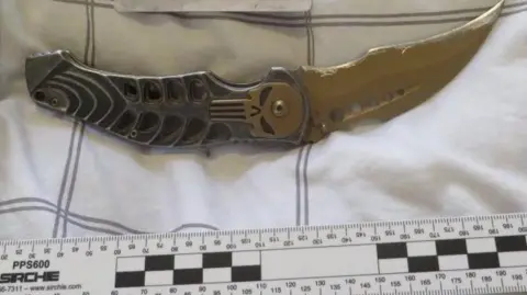 Nottinghamshire Police A curved blade seized by detectives 