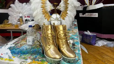 Lily May-Symonds/BBC Boots and costumes being made for the Luton carnival