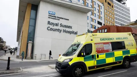 An ambulance drives past the Royal Sussex County Hospital in Brighton.