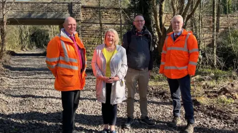 Image of Jaimie Bingham, Councillor Carolyn Renwick, Adrian Hill and Robert Smith stood on Little Eaton railway line