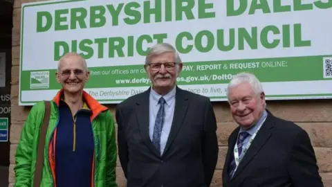 Leader of Derbyshire Dales District Council Steve Flitter is stood in the middle of Labour's Nigel Slack on his left and Neil Buttle, leader of the Green Party group on his right.