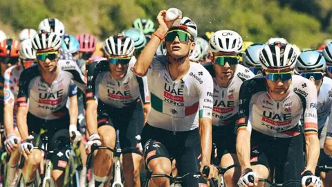 Isaac del Toro pours water on his head during stage two of the 2026 Tour de France