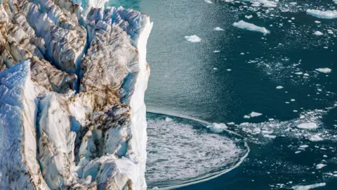 Calving at the front terminus of the Hisinger Glacier, Dickson fjord, Northeast Greenland National Park.
