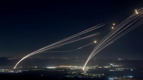 EPA A shell is fired from Israel's Iron Dome air defense system to intercept a rocket fired from southern Lebanon, over Israel's northern Galilee region, early on August 4, 2024. 