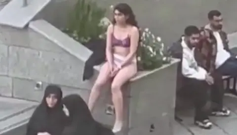 Screengrab of a video showing an Iranian woman sitting in her underwear at the Science and Research Branch of Islamic Azad University in Tehran, Iran