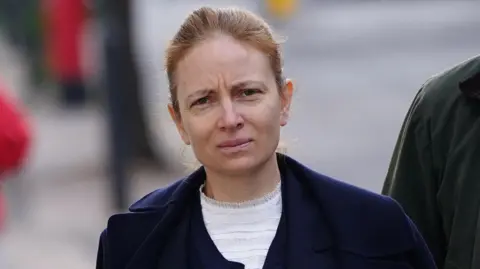 Marinela Atomei arriving at Warwick Crown Court in Leamington Spa. She is in a navy coat and white shirt.