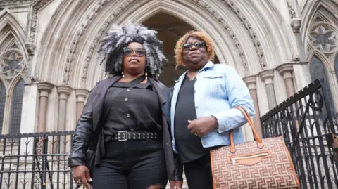 PA Bertice Pompe (left) and Bernadette Dugasse (right) outside the High Court in central London