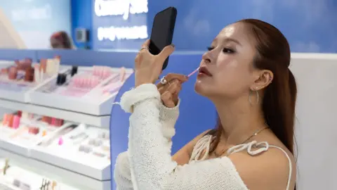 PureSeoul A woman putting on make-up at K-beauty store PureSeoul in central London