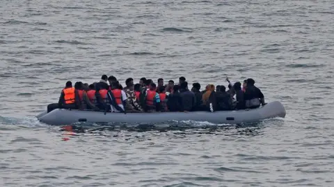 Reuters A group of migrants on an inflatable dinghy in the English Channel