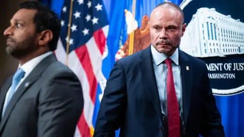 Getty Images FBI Director Kash Patel, left, and Dan Bongino, deputy director of the FBI, conduct a news conference at the Department of Justice on Thursday, December 4, 2025