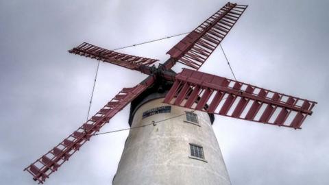 Close up of the windmill's red sails