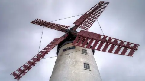 Close up of the windmill's red sails