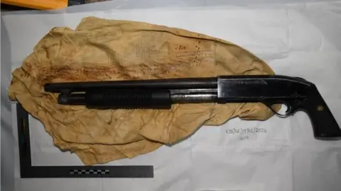 National Crime Agency A shotgun and a piece of old discoloured rag. 