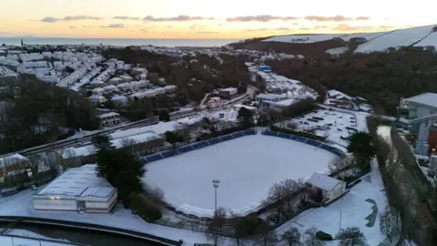 ANDREWBELL An arial view of outdoors at the NSC, you can see the Bowl covered in snow, houses around are also covered in snow at sunrise.