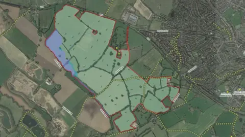 A plan of a proposed housing development with a green area marked out with a red outline to show where the homes would be built