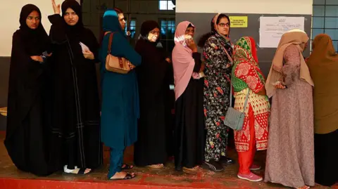 Women voters stand in queues to cast their votes at a polling station during the Kerala state assembly election in Kochi, India, on April 9, 2026. (Photo by Sivaram Venkitasubramanian/NurPhoto via Getty Images)
