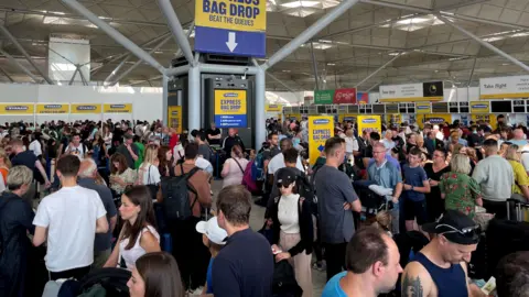 PA Large crowds of people at Stanstead's check-in hall