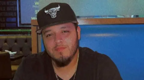 Kilmar Ábrego García, wearing a black baseball cap and T-shirt, in a candid photo