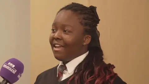 Schoolchildren speaking into a microphone