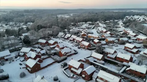 Aerial shots of a snow-covered housing estate in Norfolk