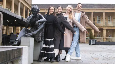 Julie Nunès, Albert González Orts, Heather Lehan and Saeka Shirai pose with a statue of Anne Lister at Halifax Piece Hall 