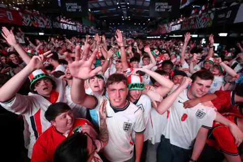 England fans celebrate in a crowd.