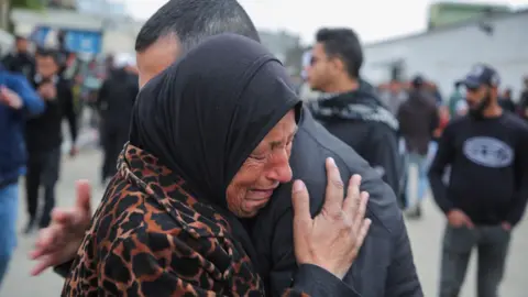 A woman cries as Palestinian prisoners are greeted after being released from an Israeli jail, as part of a hostages-prisoners swap and a ceasefire deal in Gaza between Hamas and Israel, in Khan Younis in the southern Gaza Strip, February 8, 2025